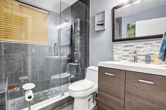 a bathroom with a sink toilet and shower