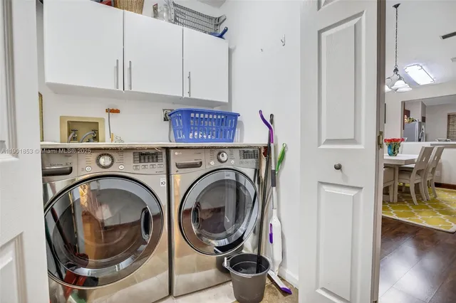 a utility room with sink dryer and washer