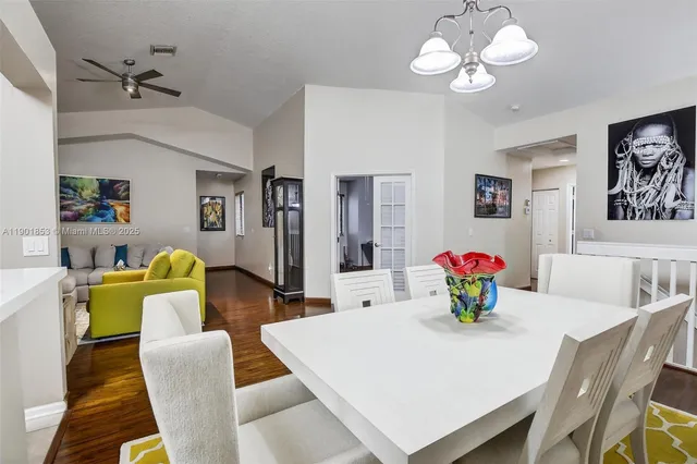 a view of a dining room with furniture and chandelier