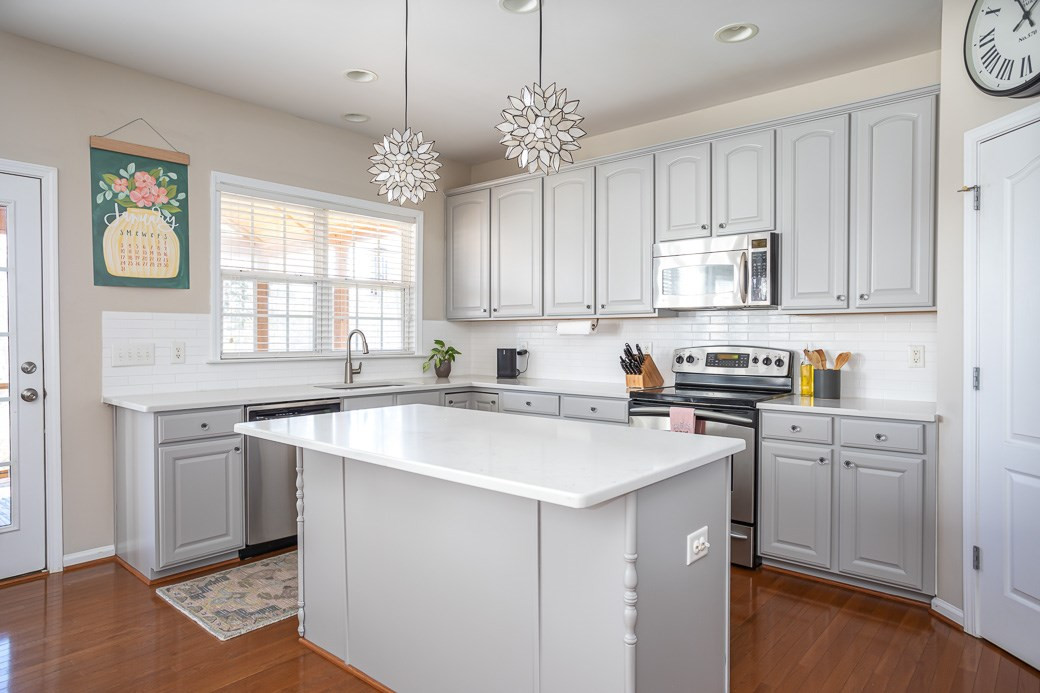 8206 Marvino Lane Raleigh, NC 27613 - Photo 5 of 30 This kitchen features some great updates! New quartz countertops, professionally painted cabinets, and new pendants lights. Kitchen
