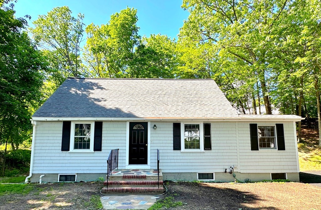 a house that has a tree in front of the house