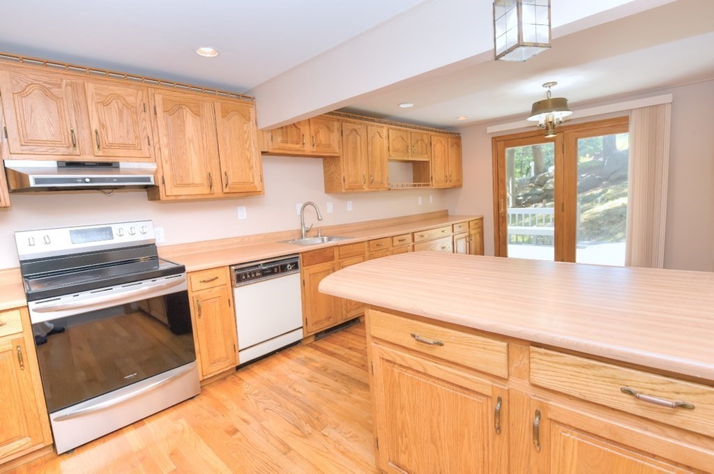 165 R Green Street Stoneham, MA 02180 - Photo 13 of 42 a kitchen with stainless steel appliances granite countertop a sink and a stove