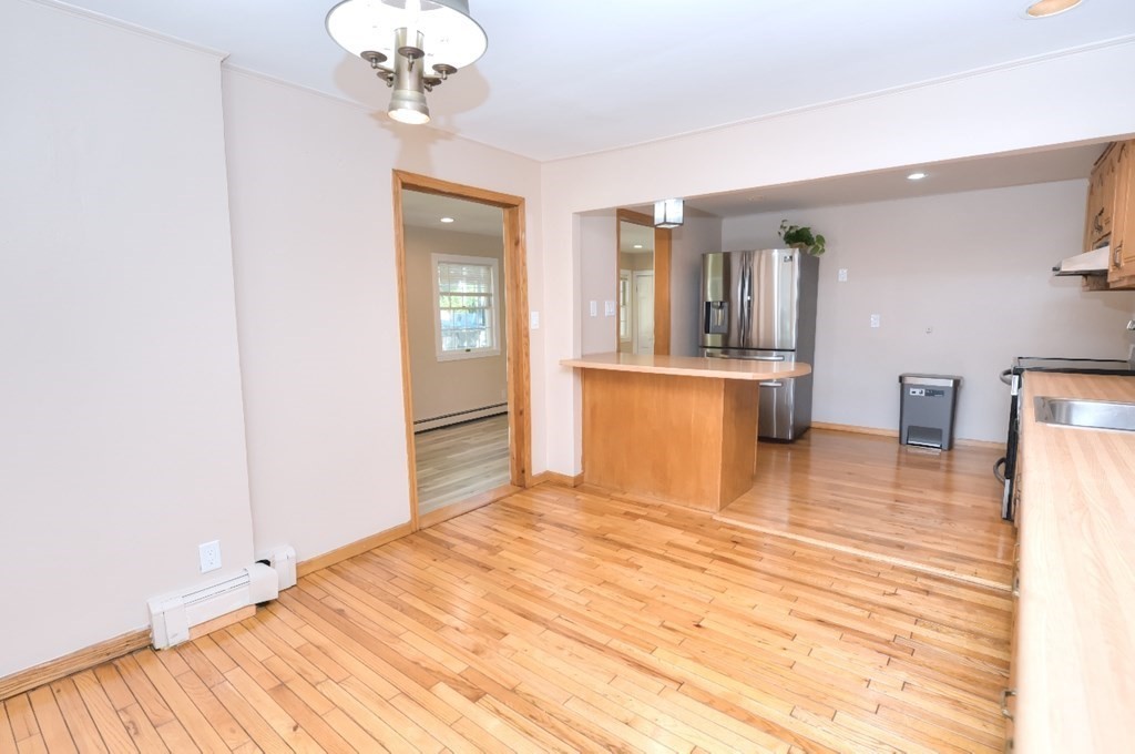 165 R Green Street Stoneham, MA 02180 - Photo 15 of 42 a view of a livingroom with a chandelier