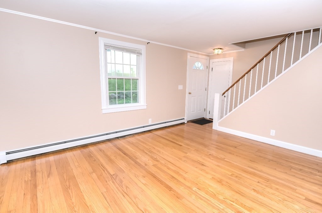 165 R Green Street Stoneham, MA 02180 - Photo 17 of 42 a view of an empty room with wooden floor and a window