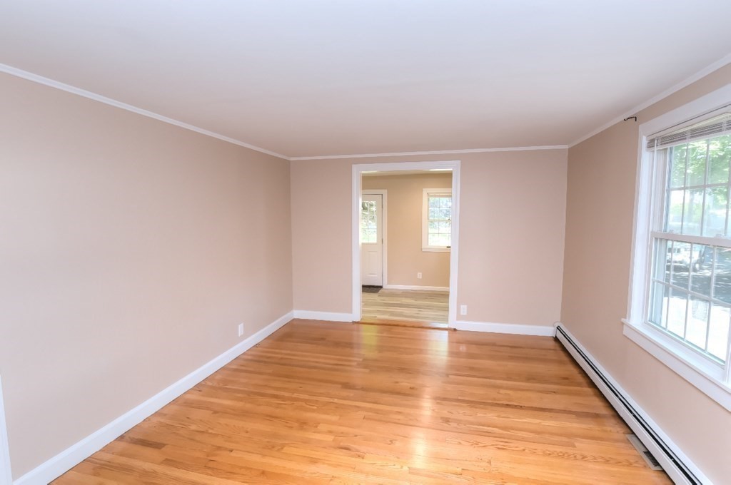 165 R Green Street Stoneham, MA 02180 - Photo 20 of 42 a view of an empty room with wooden floor and a window