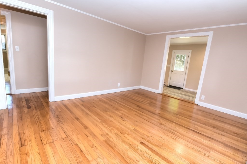165 R Green Street Stoneham, MA 02180 - Photo 21 of 42 a view of an empty room with wooden floor and a window