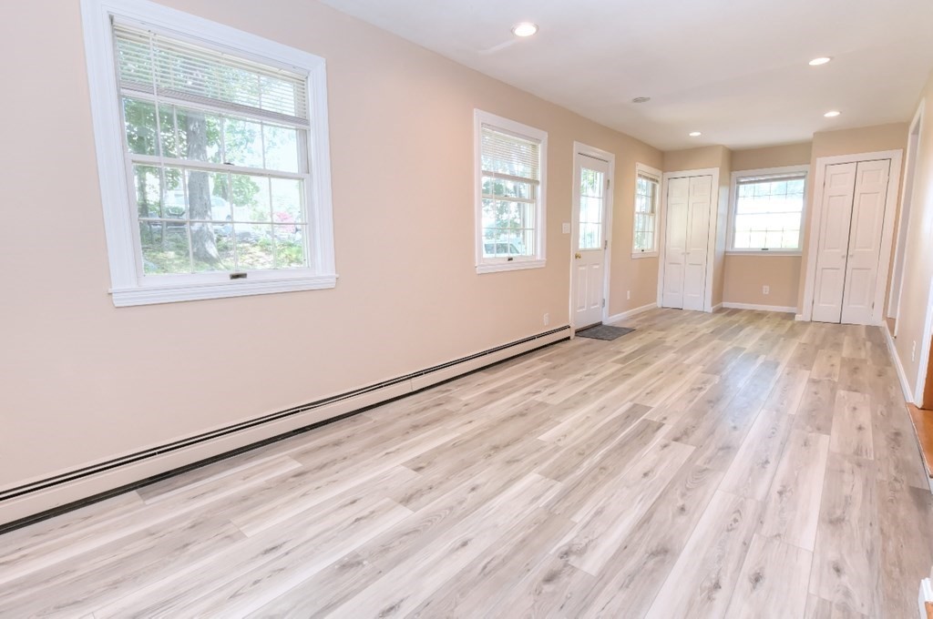165 R Green Street Stoneham, MA 02180 - Photo 22 of 42 a view of an empty room with wooden floor and a window