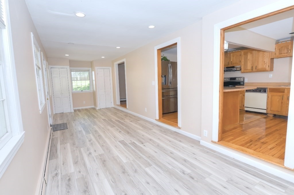 165 R Green Street Stoneham, MA 02180 - Photo 24 of 42 a view of a room with wooden floor and a bedroom