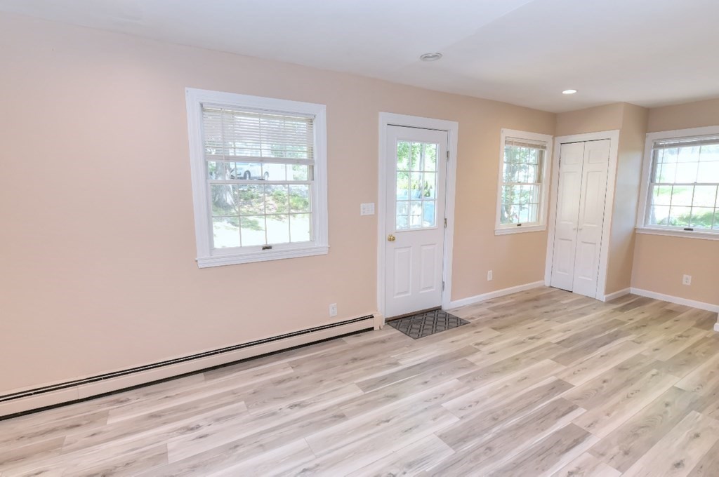 165 R Green Street Stoneham, MA 02180 - Photo 25 of 42 a view of an empty room with wooden floor and a window