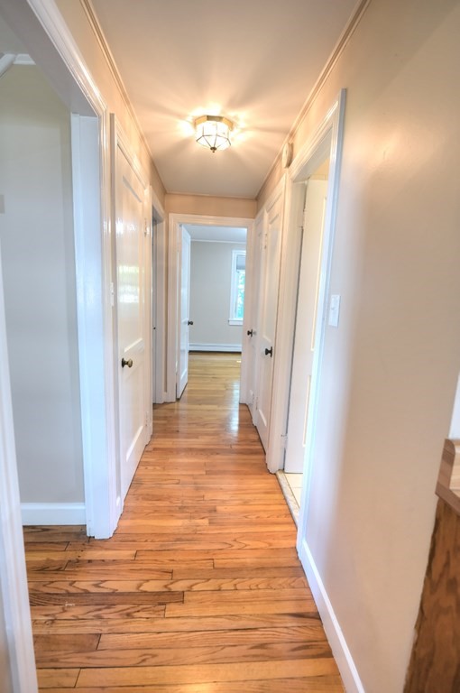 165 R Green Street Stoneham, MA 02180 - Photo 26 of 42 a view of a hallway with wooden floor
