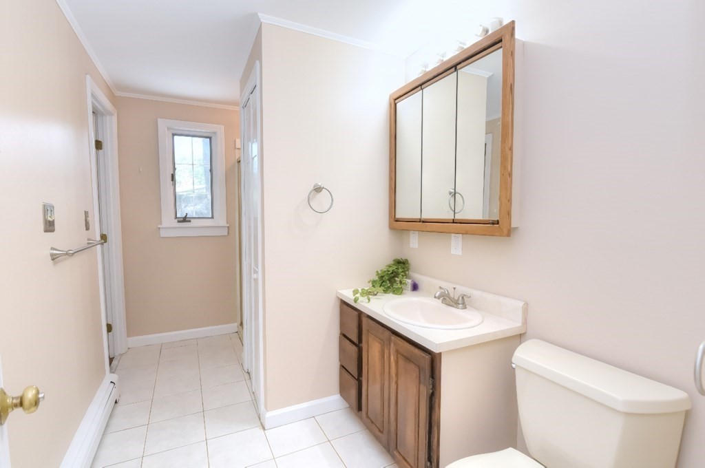 165 R Green Street Stoneham, MA 02180 - Photo 27 of 42 a bathroom with a toilet sink and mirror