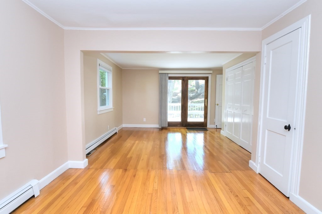 165 R Green Street Stoneham, MA 02180 - Photo 29 of 42 a view of an empty room with wooden floor and a window