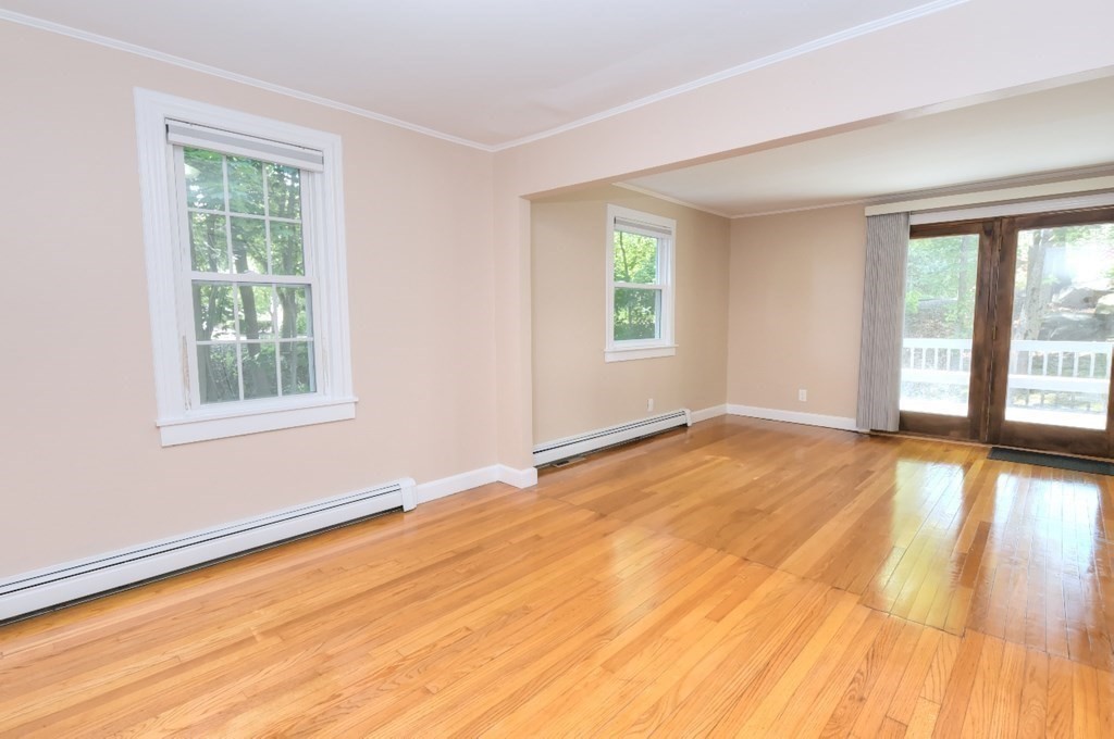 165 R Green Street Stoneham, MA 02180 - Photo 31 of 42 a view of an empty room with wooden floor and a window