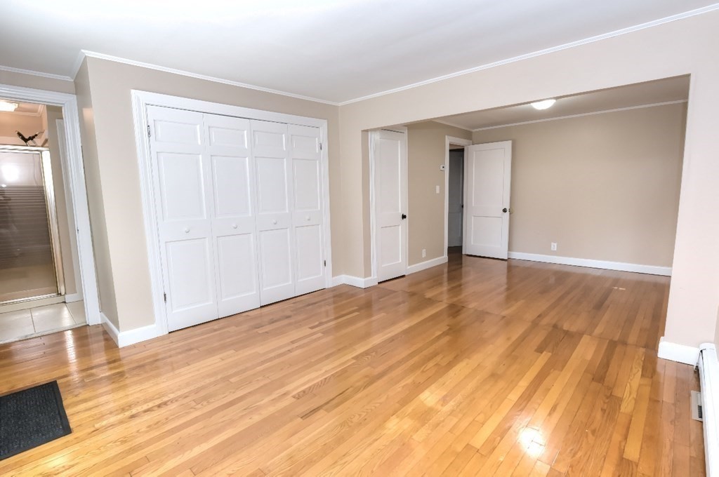 165 R Green Street Stoneham, MA 02180 - Photo 32 of 42 a view of an empty room with wooden floor