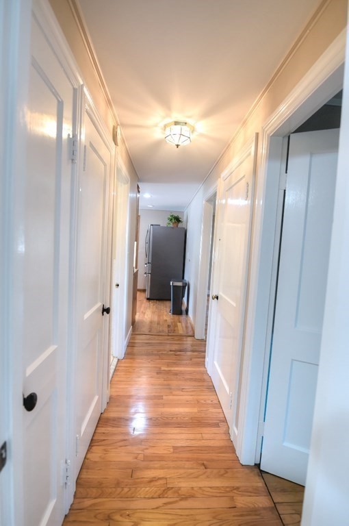 165 R Green Street Stoneham, MA 02180 - Photo 33 of 42 a view of a hallway with wooden floor and a bathroom