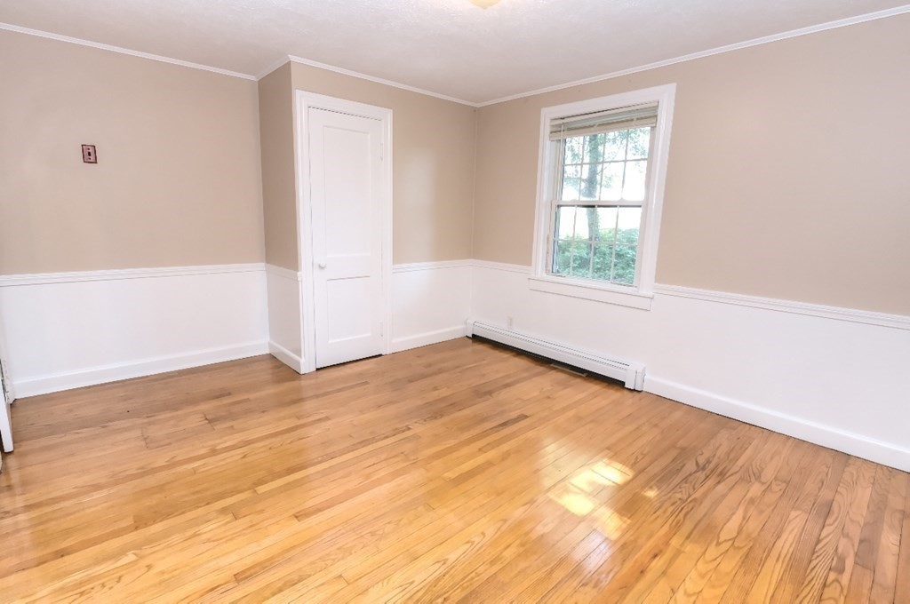 165 R Green Street Stoneham, MA 02180 - Photo 35 of 42 an empty room with wooden floor and windows