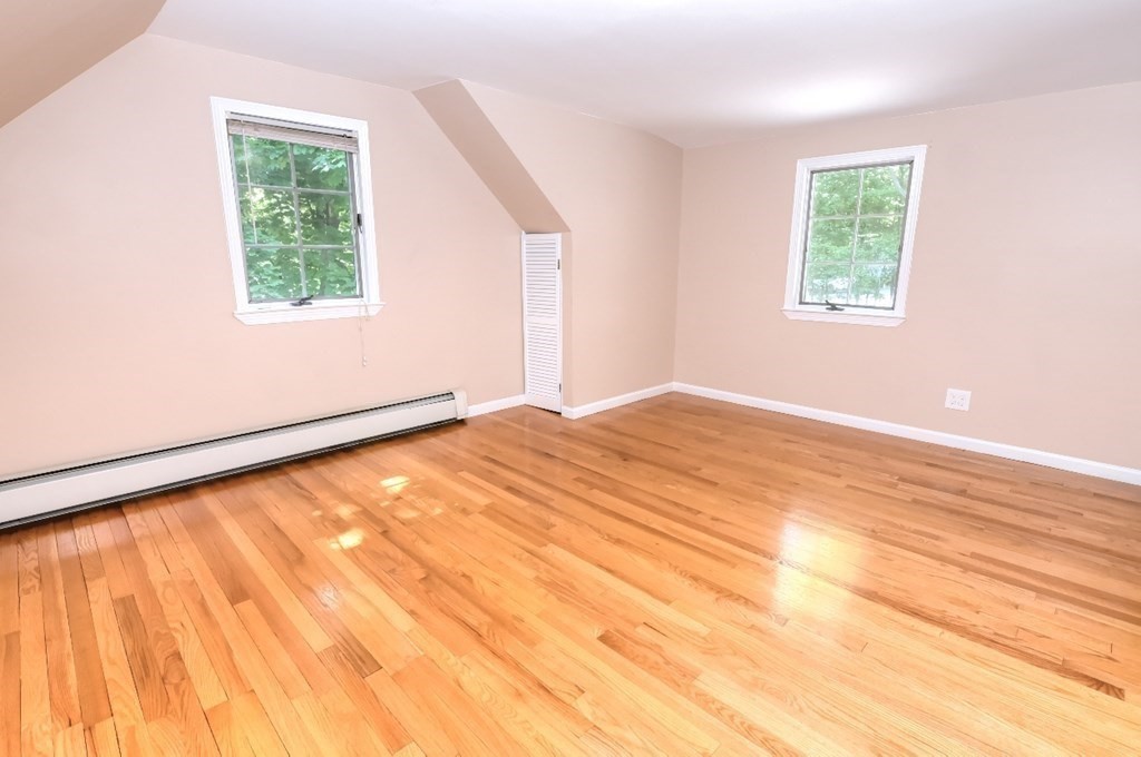 165 R Green Street Stoneham, MA 02180 - Photo 36 of 42 a view of an empty room with wooden floor and a window