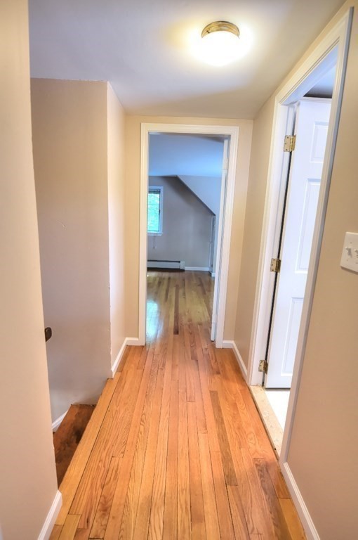 165 R Green Street Stoneham, MA 02180 - Photo 37 of 42 a bedroom with a bed and a mirror