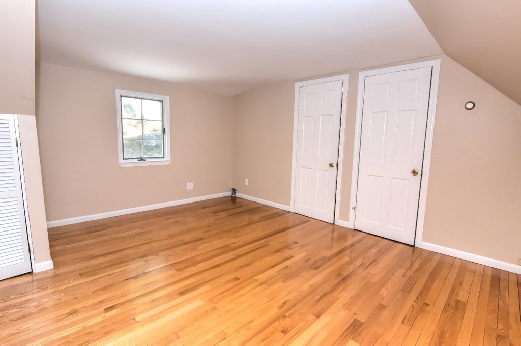 165 R Green Street Stoneham, MA 02180 - Photo 38 of 42 a view of empty room with wooden floor and fan