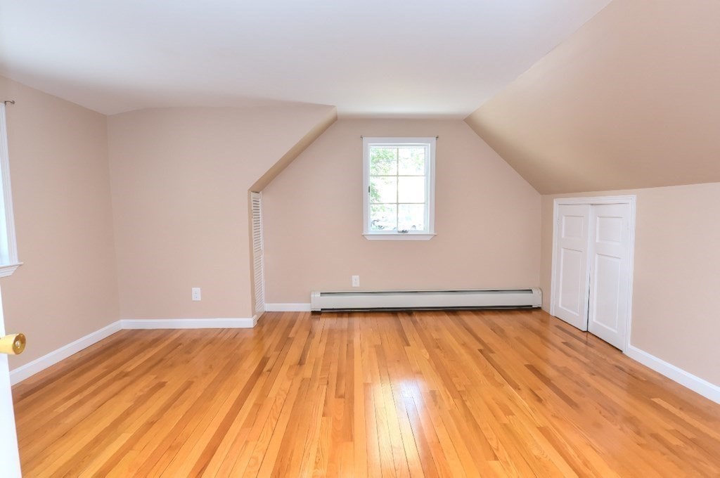 165 R Green Street Stoneham, MA 02180 - Photo 39 of 42 a view of an empty room with wooden floor and a window