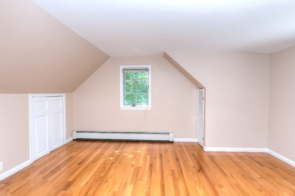 165 R Green Street Stoneham, MA 02180 - Photo 40 of 42 an empty room with wooden floor and windows