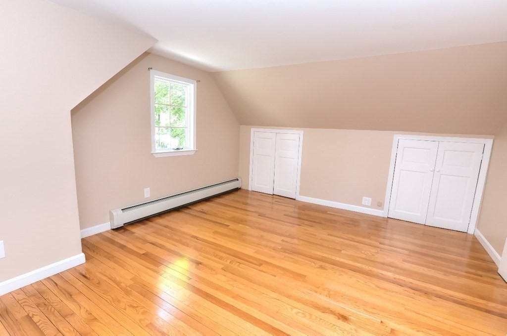 165 R Green Street Stoneham, MA 02180 - Photo 41 of 42 an empty room with wooden floor and windows