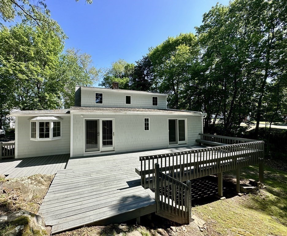 165 R Green Street Stoneham, MA 02180 - Photo 5 of 42 a view of a roof deck with wooden fence and trees