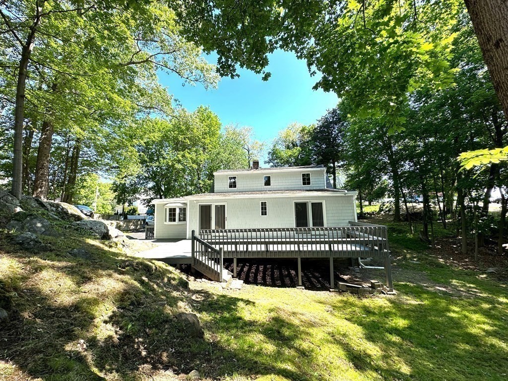 165 R Green Street Stoneham, MA 02180 - Photo 6 of 42 a view of a house with a small yard and large trees