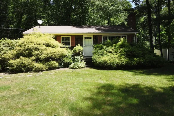 a front view of house with yard and green space