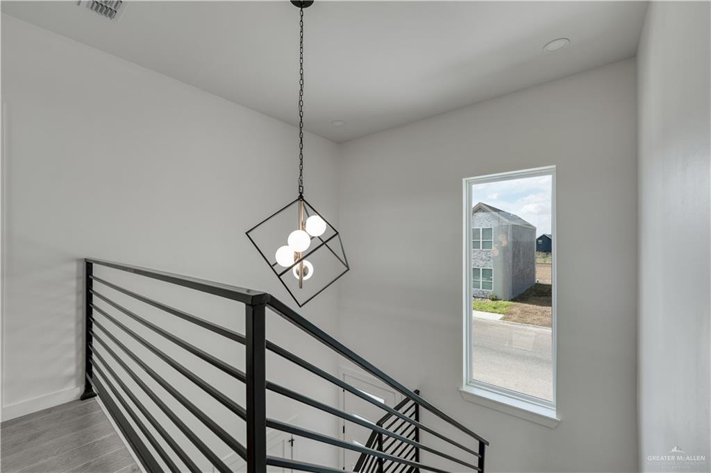 5408 North Crown Point Pharr, TX 78577 - Photo 12 of 19 a view of a hallway with wooden floor and staircase