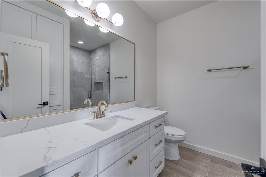 5408 North Crown Point Pharr, TX 78577 - Photo 15 of 19 a bathroom with a sink a toilet and a mirror