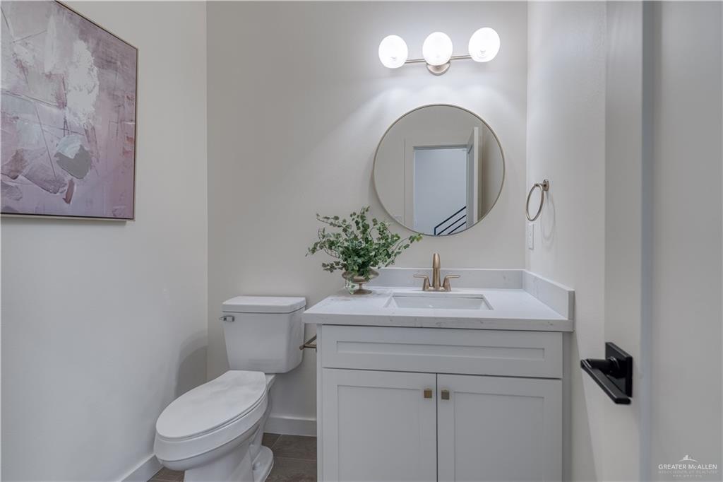 5408 North Crown Point Pharr, TX 78577 - Photo 16 of 19 a bathroom with a sink mirror vanity and toilet