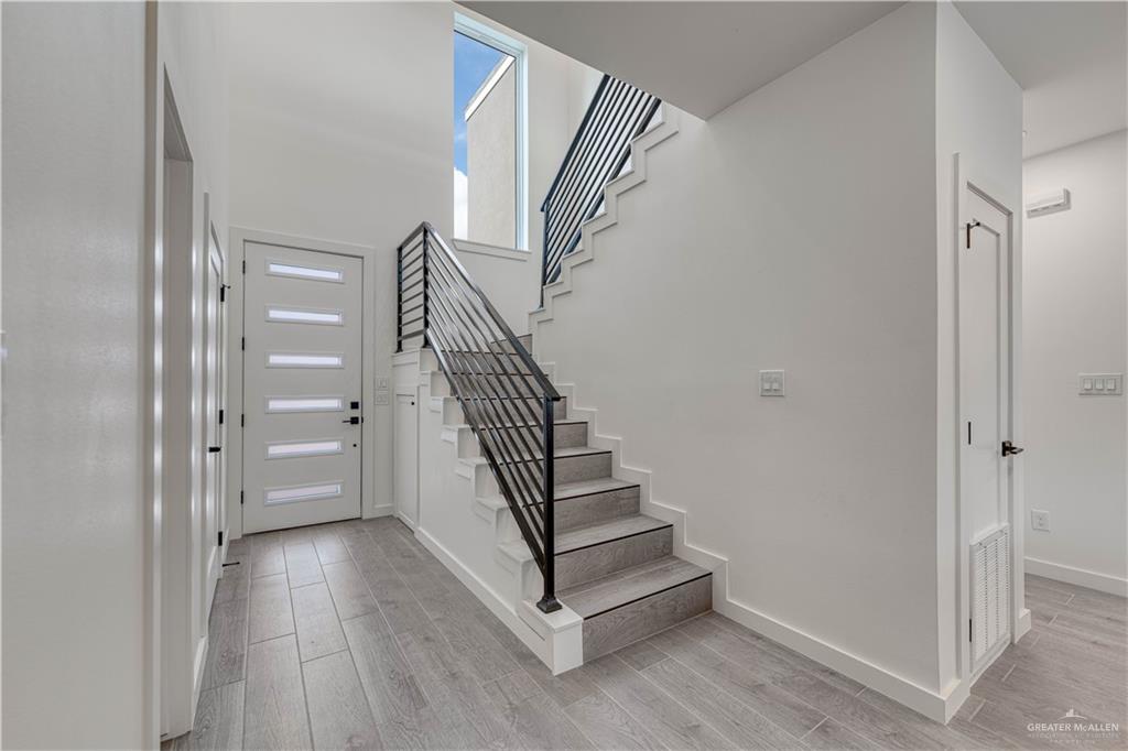 5408 North Crown Point Pharr, TX 78577 - Photo 8 of 19 a view of entryway with wooden floor and stairs
