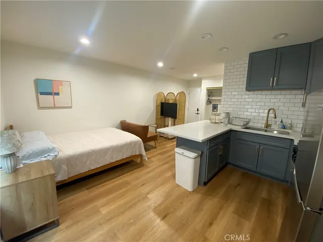a spacious bedroom with a bed and a sink