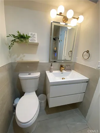 a bathroom with a sink mirror and toilet