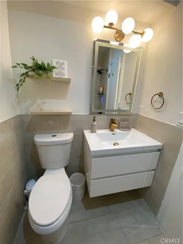 a bathroom with a sink mirror and toilet