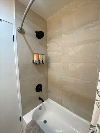a bathroom with a tub and a shower
