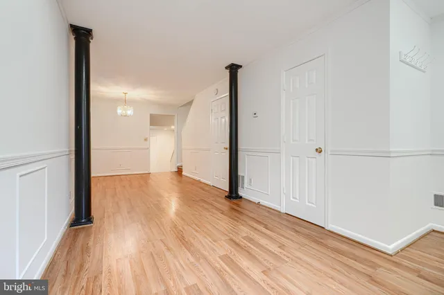 a view of empty room with wooden floor