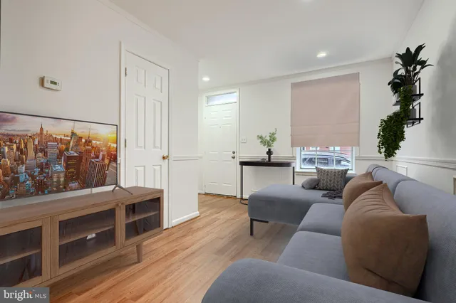 a living room with furniture window and wooden floor