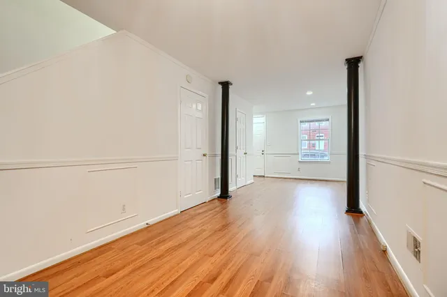 a view of a room with wooden floor
