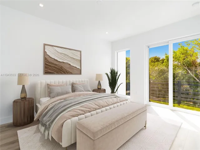 a bedroom with a large bed and a large window