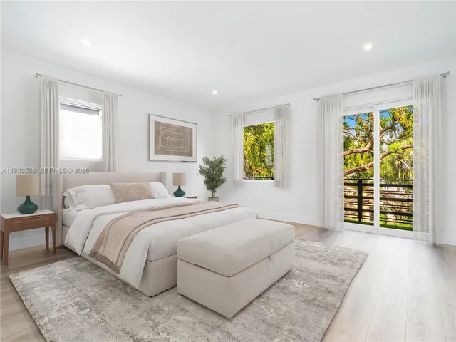 a spacious bedroom with a bed and a window