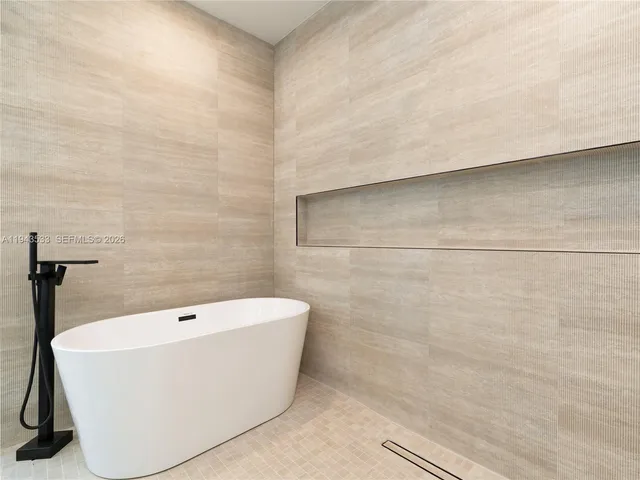 a white bath tub sitting in a bathroom