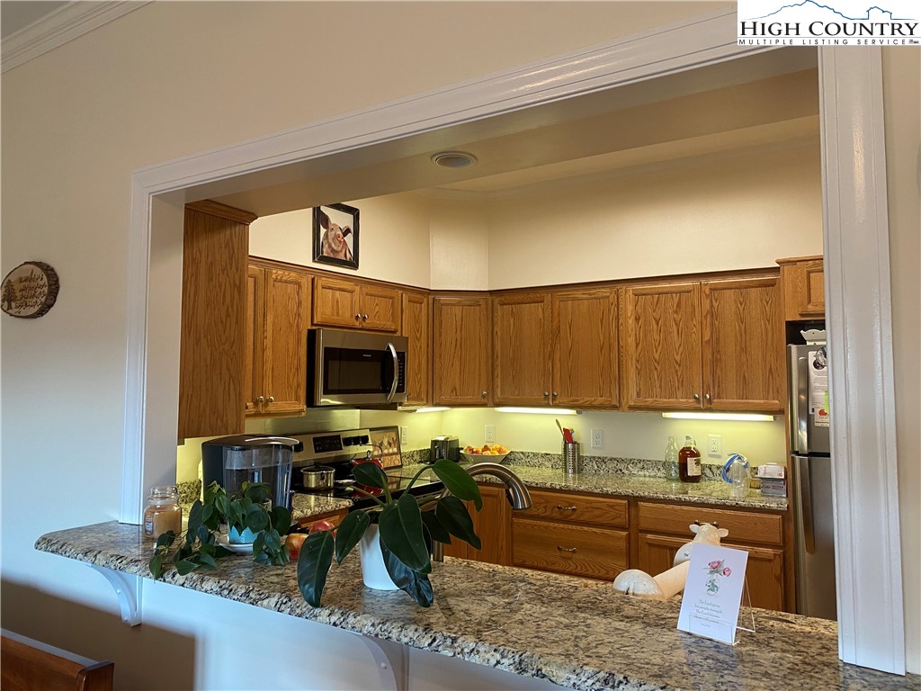 148 North Ridge Circle, Unit B Boone, NC 28607 - Photo 19 of 36 a kitchen with sink refrigerator and microwave