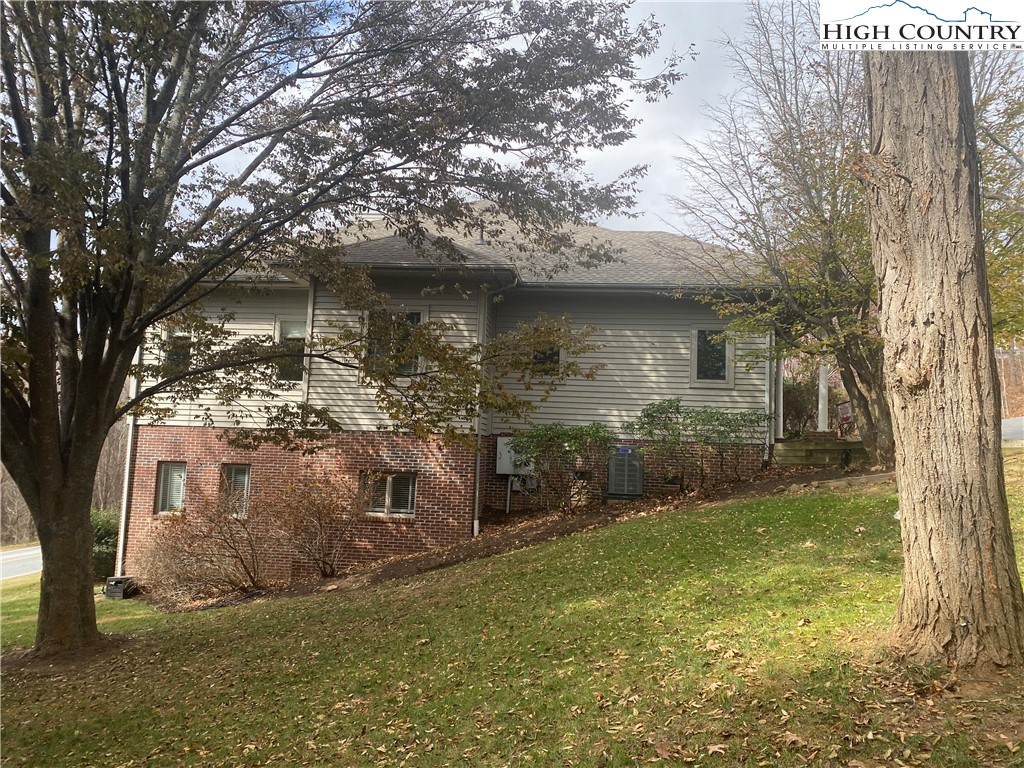 148 North Ridge Circle, Unit B Boone, NC 28607 - Photo 5 of 36 a view of a yard in front of a house with a large tree