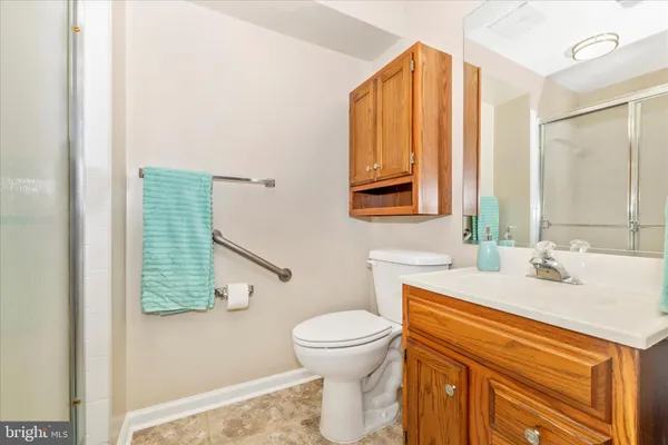 a bathroom with a sink a toilet and mirror