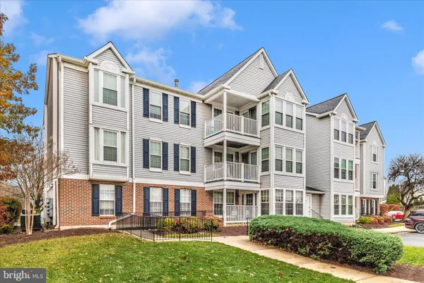 a front view of a residential apartment building with a yard