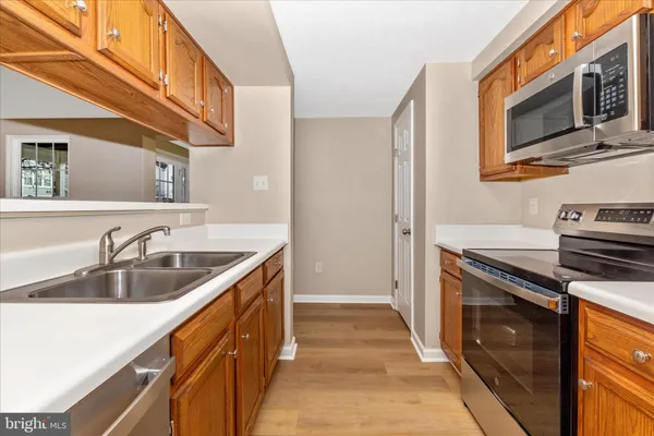 a kitchen with a sink stove and microwave