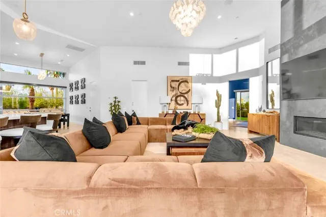 a kitchen with stainless steel appliances a stove a sink a microwave a dining table and chairs