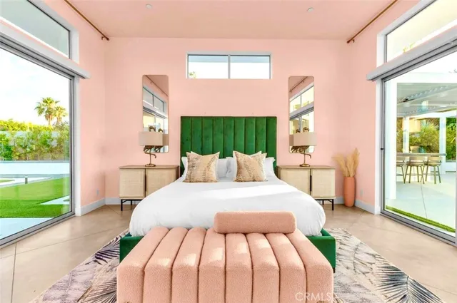 a view of a terrace with couches and wooden fence